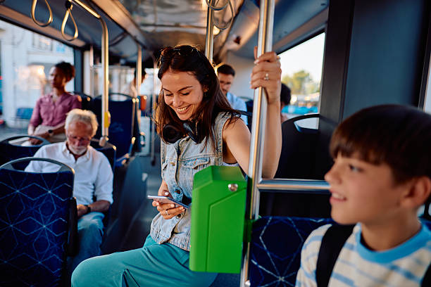 istock Young woman using smartphone while traveling by bus 2220843557