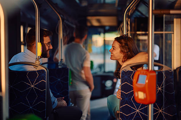 istock Young couple flirting on the bus during their daily commute 2220843595