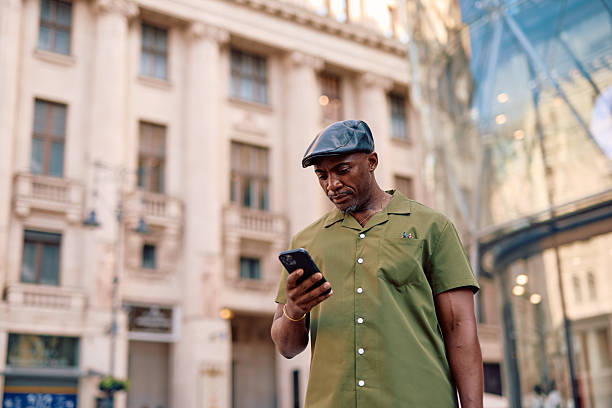 istock Stylish mature man using smartphone in urban setting, Bucharest, Romania 2220843886
