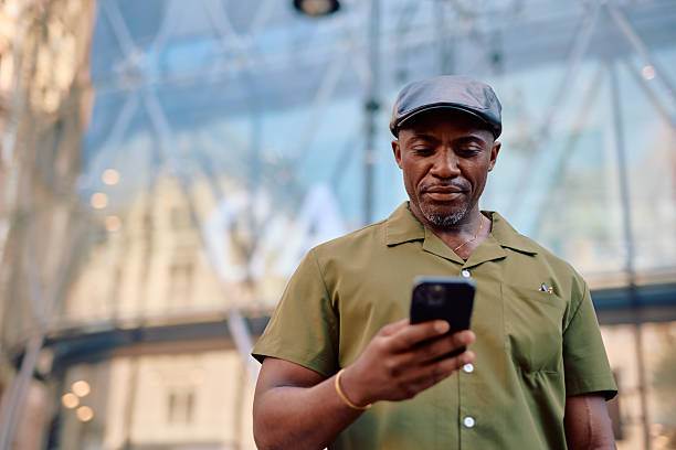 istock Stylish mature man using smartphone in urban environment 2220843899