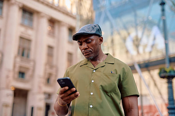 istock Stylish mature man using smartphone in urban setting 2220843900