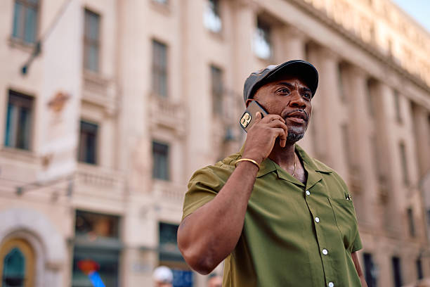 istock Stylish mature man talking on smartphone in urban setting 2220843926