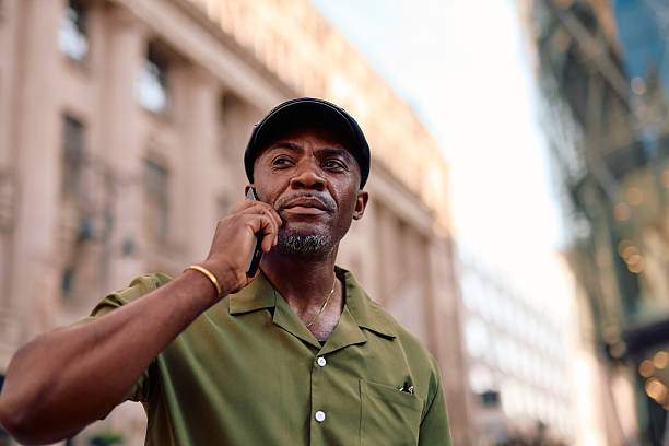 istock Stylish mature man talking on smartphone in urban setting 2220843930