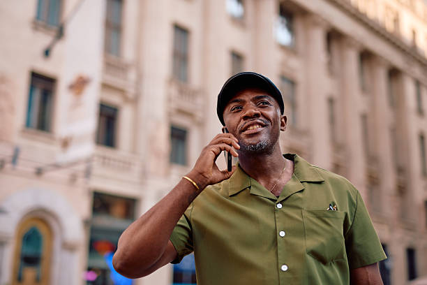 istock Stylish man talking on phone in city center 2220843934