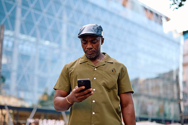 istock Stylish mature man using smartphone in urban setting 2220843952
