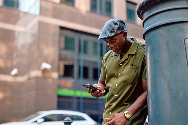 istock Stylish mature man using smartphone in urban setting 2220844165