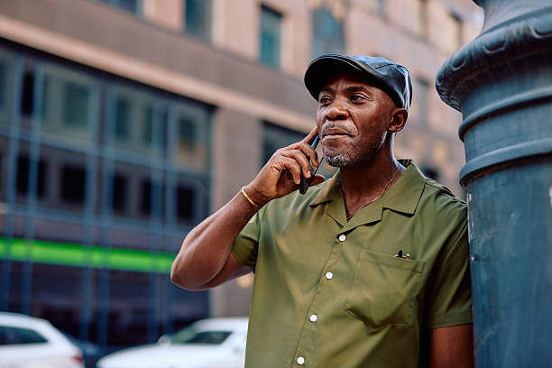 Stylish mature man talking on smartphone in urban setting