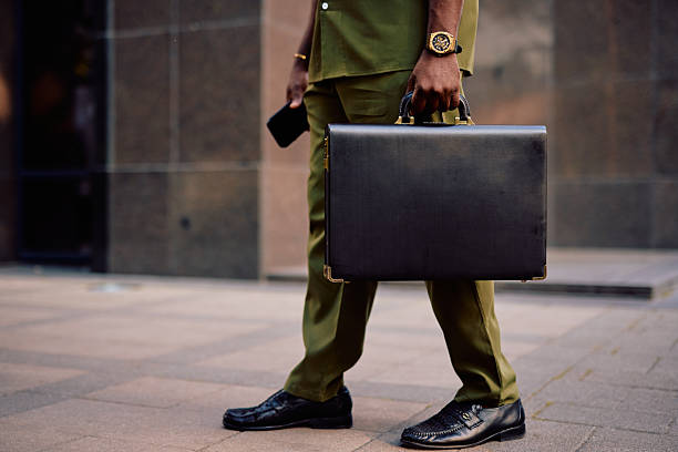 Three men in suits walking with rolling luggage. Suitable for business travel, professional attire, corporate lifestyle, teamwork, leadership, and travel concepts for commercial use.