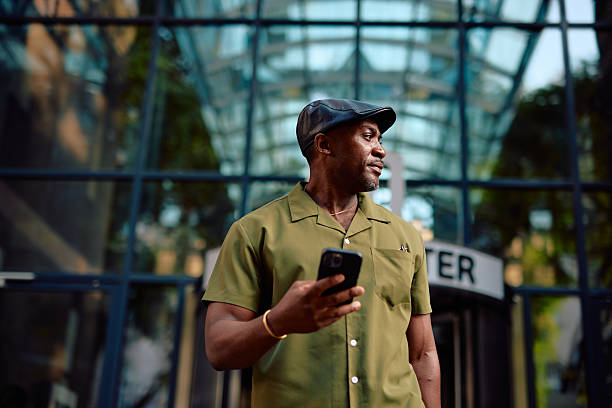 istock Stylish mature man using smartphone in urban setting 2220844350