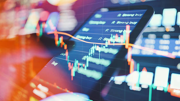istock fintech mobile app in use with dynamic trading digital trading platform on smartphone with glowing financial data charts and market buy-sell interface 2220846392
