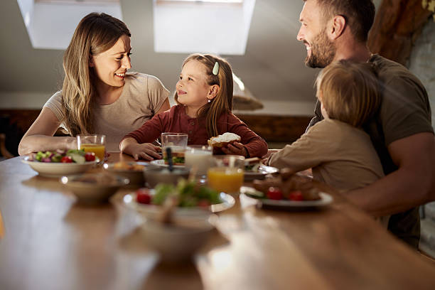 istock Happy family enjoying during breakfast at dining table. 2220846488