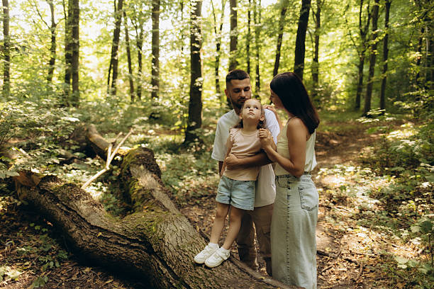 Three kids hiking and discovering spring forest. Happy childhood.