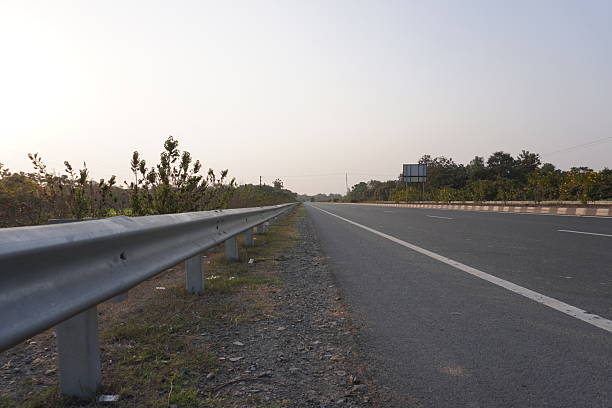istock A metal guardrail beside the highway, a clear blue sky above 2220853123