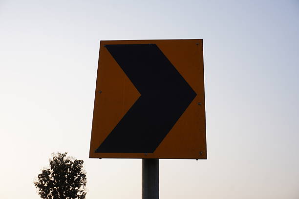 A close-up of right turn signboard attached with a iron pole