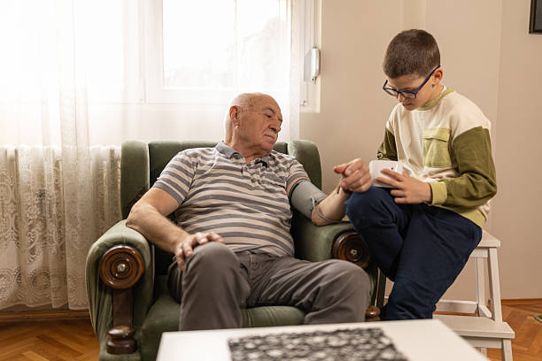 istock Boy measuring grandpa's blood pressure 2220860322