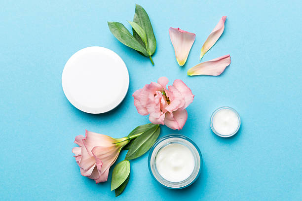 istock Composition with cosmetic products and beautiful roses on color background. Flat lay 2220863676