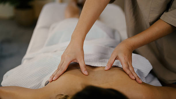 istock Therapist giving professional deep tissue massage on woman back. Well ness concept 2220864842