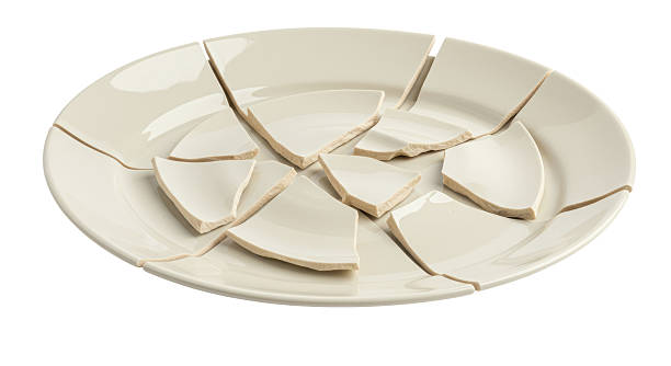istock Isolated Broken White Plate with Scattered Fragments 2220866274