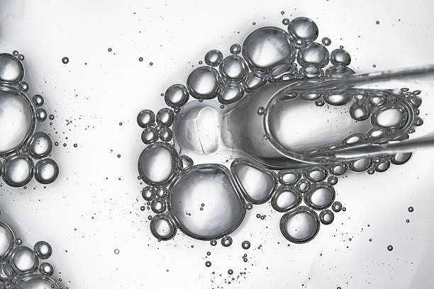 istock Pipette with hyaluronic acid, liquid texture with bubbles top view, macro. Cosmetic background with face serum. 2220869266
