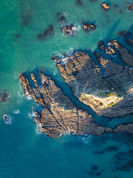istock Coastal rocks bathed in turquoise waters. 2220869762