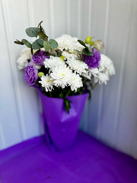 white chrysanthemums and purple eustomas bouquet
