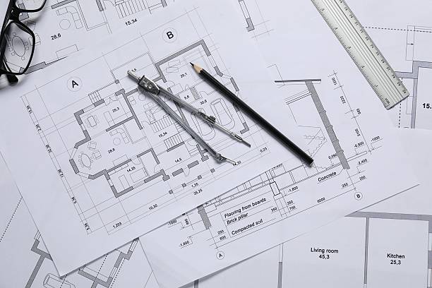 istock Different architectural drawings, ruler, divider, pencil and glasses on table, flat lay 2220869946