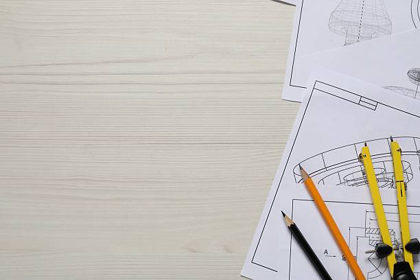 istock Different engineering drawings, pencils and divider on wooden table, flat lay. Space for text 2220869958