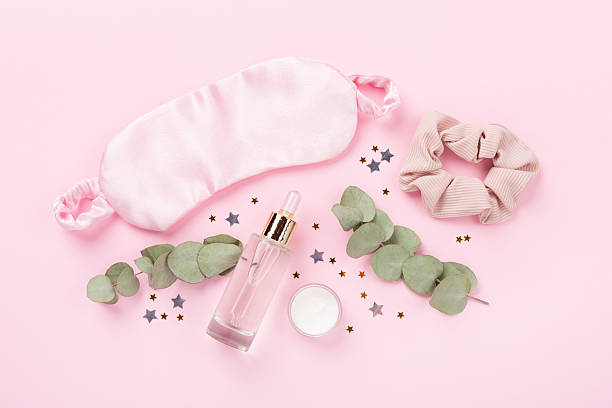 istock Sleeping mask with accessories on color background, top view. Sleeping routine concept 2220872058