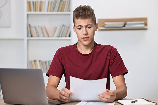 istock Tired student having stress before exam at table indoors 2220872739