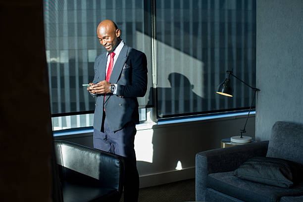 istock Businessman checking his phone in a Hotel room 2220873304