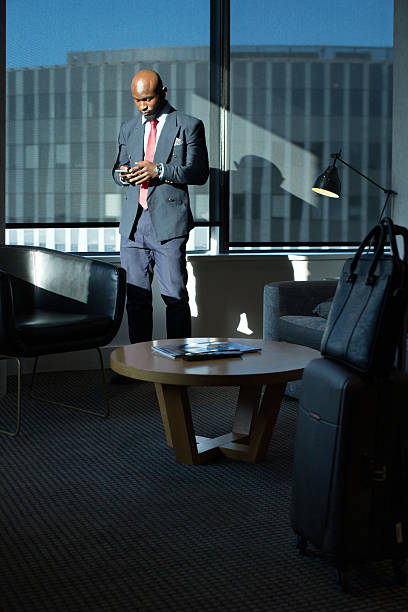 istock Businessman checking his phone in a Hotel room 2220873334
