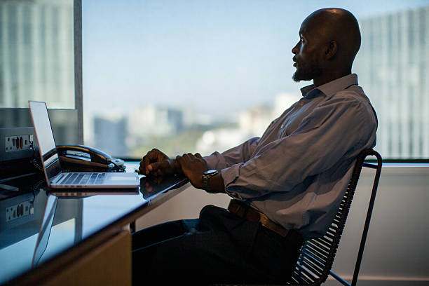 istock Businessman sitting at the table and having a break from the computer 2220873403