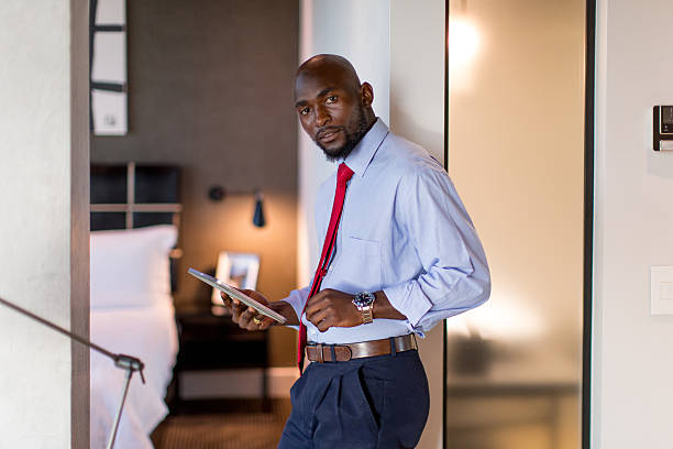 istock Businessman using digital tablet in his Hotel room 2220873531