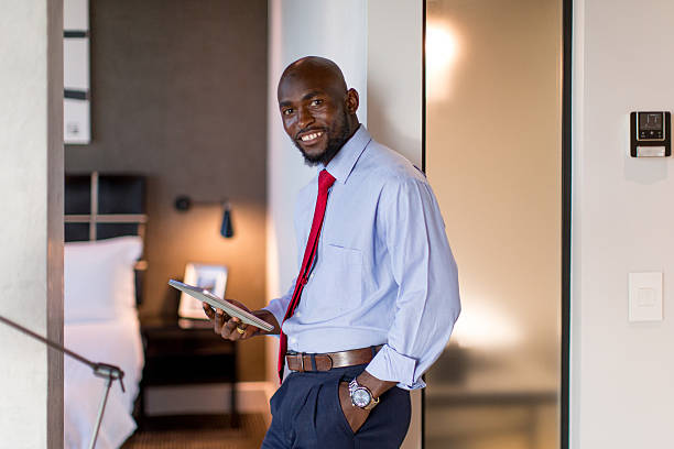 istock Businessman using digital tablet in his Hotel room 2220873532