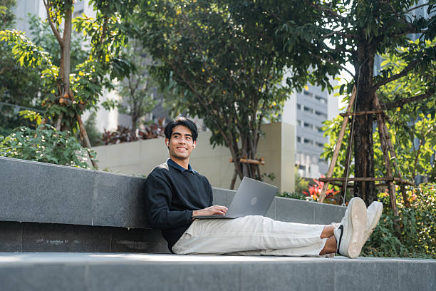 istock Young man smiling at his smartphone while listening to mindfulness podcast 2220874916