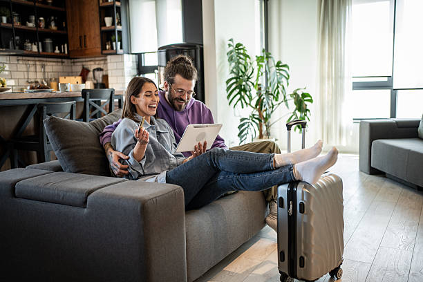 istock Happy couple planning vacation using digital tablet and credit card 2220875916