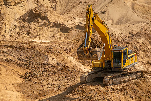istock A caterpillar tractor works with a bucket in a sand pit. Sand mining 2220879012
