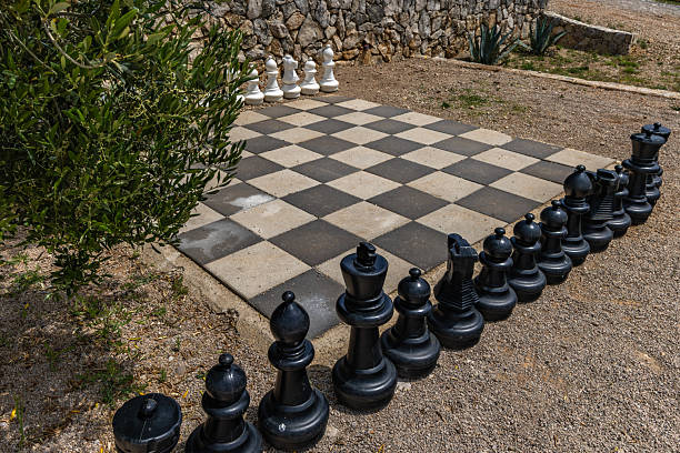 istock A chessboard with pawns and chess pieces on the beach 2220879136