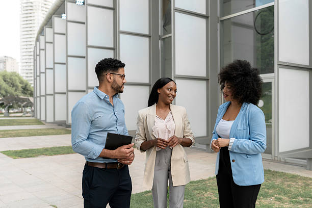 istock Multiracial diverse business team discussing a new project outside office building 2220879919