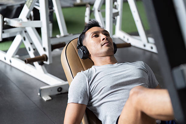 Leg Press and Strength. Man exercising on leg press machine in gym.