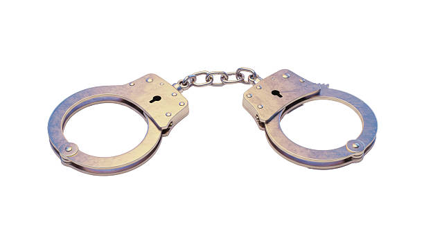 istock Isolated Silver Handcuffs for Law Enforcement and Security 2220889318