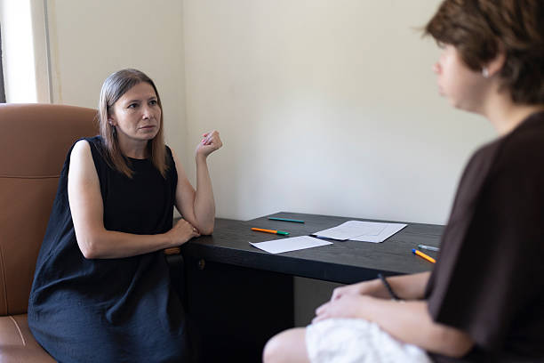 istock Psychologist listening to patient during therapy session 2220890101