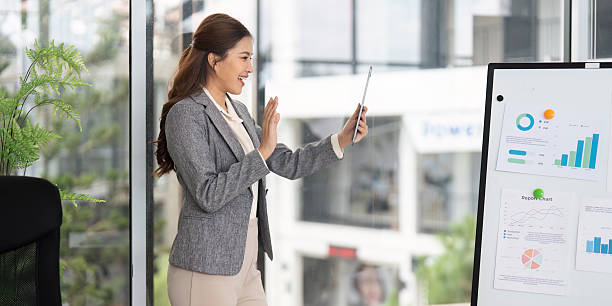 istock Virtual Presentation. Businesswoman conducting a video call while presenting data in the office. 2220890312