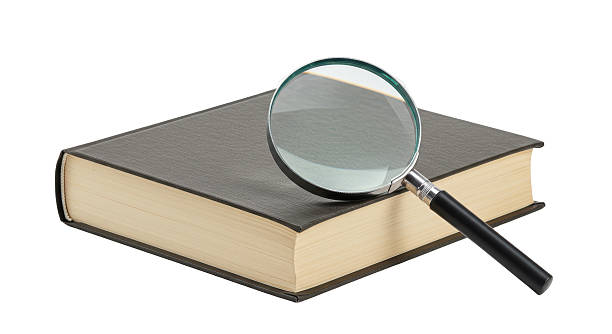 istock Isolated Magnifying Glass on Book for Research 2220890340