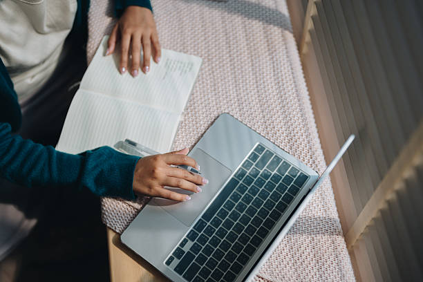 Woman enjoying her online class, attentively taking notes as she stays engaged and focused