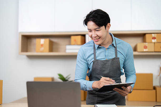 istock Entrepreneur reviewing inventory on laptop in a modern workspace 2220890859