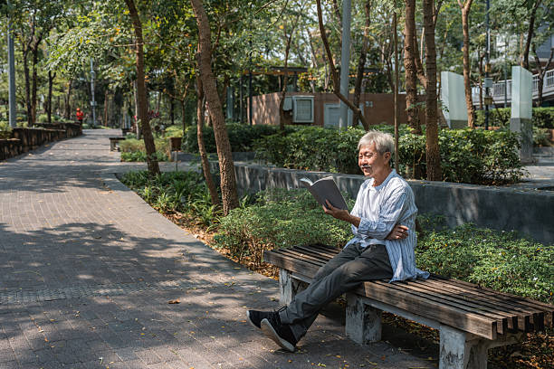 istock Senior Man Reading a Book Peacefully in the Park 2220891945