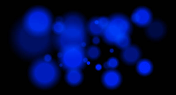 istock Large soft blue bokeh circles with glow on black background, creating a dreamy abstract field. Suitable for festive, sci-fi or digital designs. 2220892579