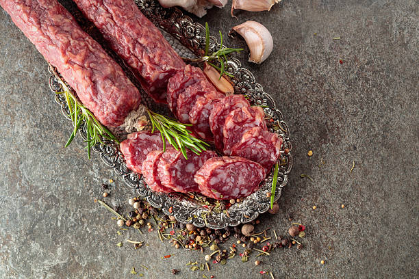istock Sliced smoked sausage on a small silver tray. 2220892607