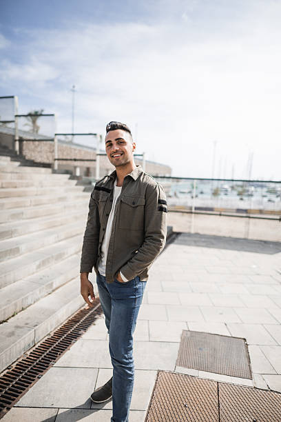 istock cheerful man standing in the street 2220893329